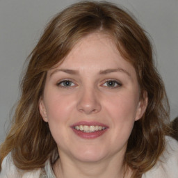 Joyful white young-adult female with medium  brown hair and blue eyes