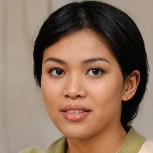 Joyful asian young-adult female with medium  brown hair and brown eyes