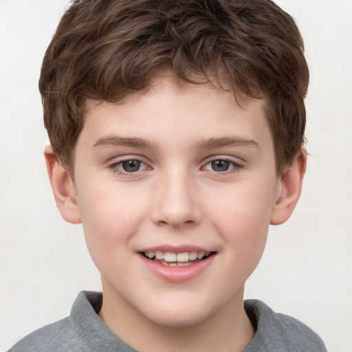 Joyful white child male with short  brown hair and grey eyes