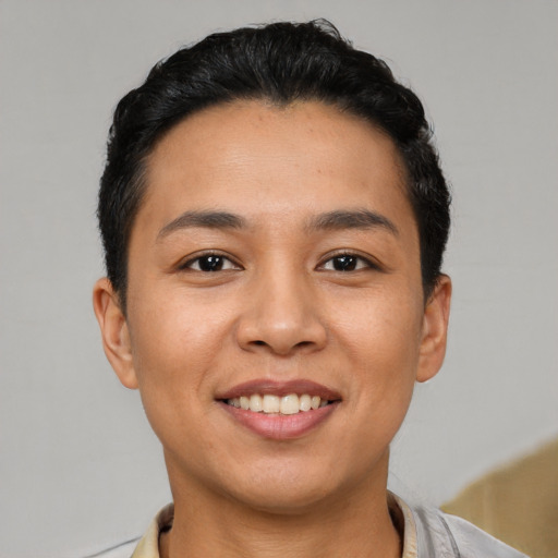 Joyful latino young-adult female with short  black hair and brown eyes