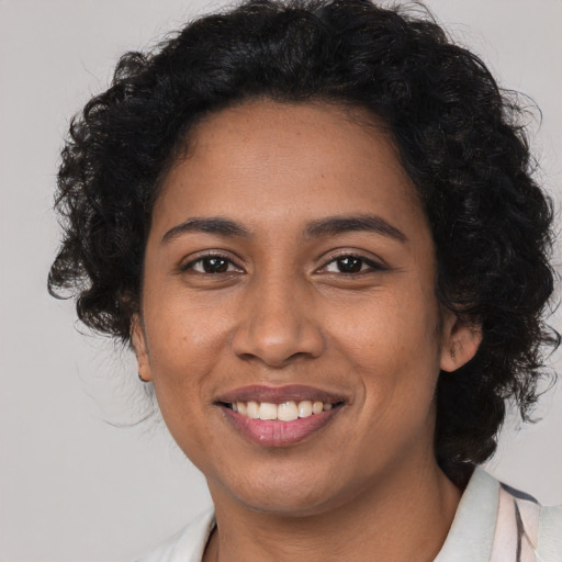 Joyful latino young-adult female with medium  brown hair and brown eyes