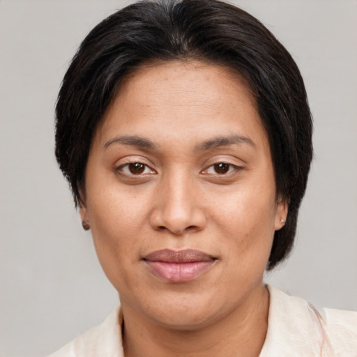 Joyful asian adult female with short  brown hair and brown eyes