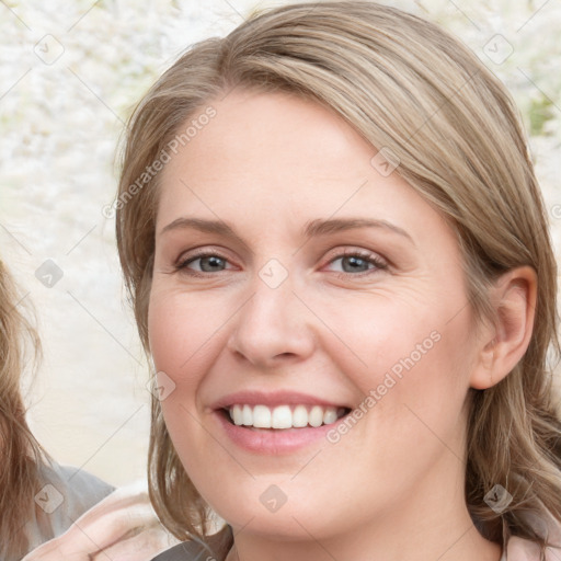 Joyful white young-adult female with medium  brown hair and blue eyes