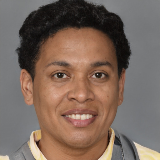 Joyful latino adult male with short  brown hair and brown eyes
