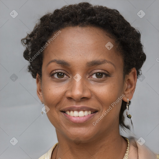 Joyful black young-adult female with short  brown hair and brown eyes