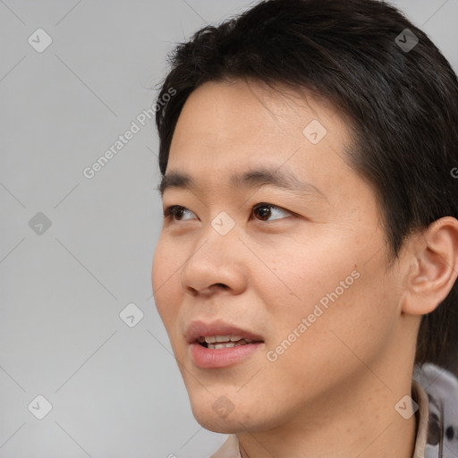 Joyful asian young-adult male with short  black hair and brown eyes