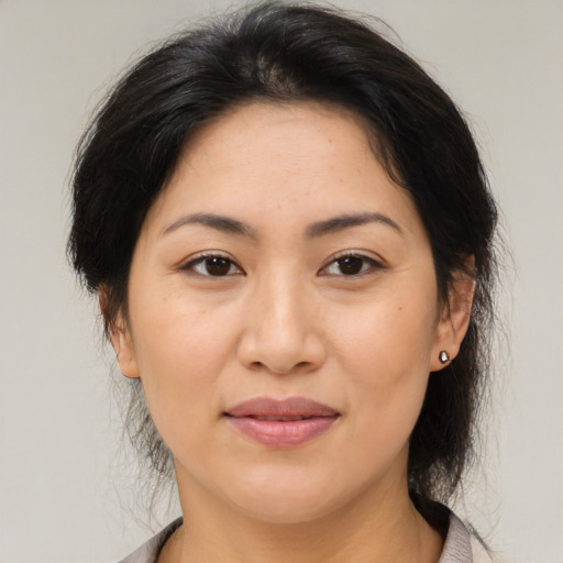Joyful asian young-adult female with medium  brown hair and brown eyes