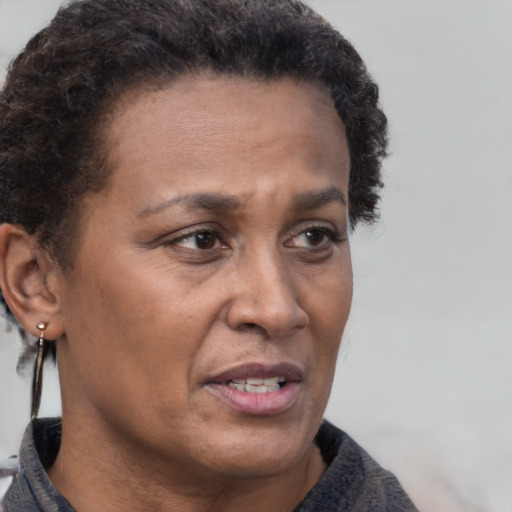 Joyful black adult female with short  brown hair and brown eyes