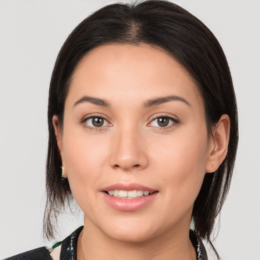 Joyful white young-adult female with medium  brown hair and brown eyes