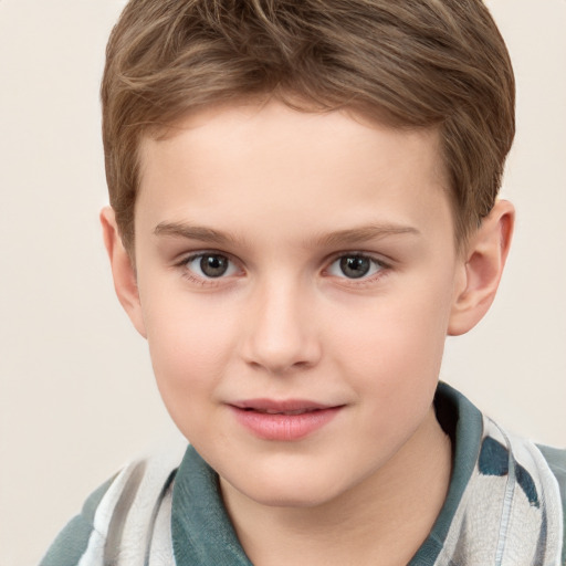 Joyful white child male with short  brown hair and grey eyes