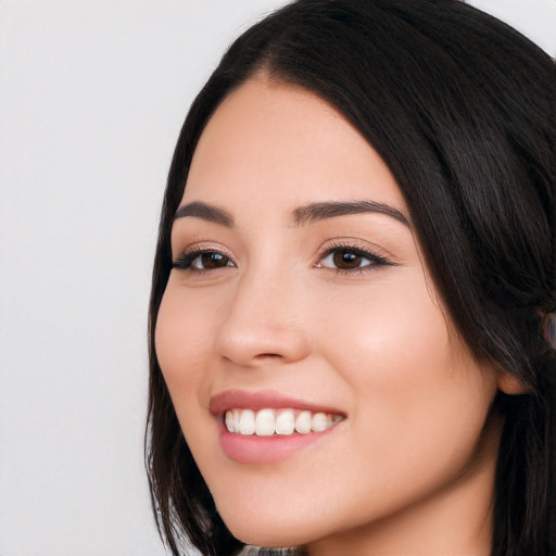 Joyful white young-adult female with long  black hair and brown eyes