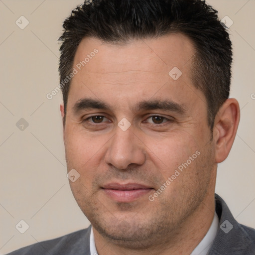 Joyful white adult male with short  brown hair and brown eyes