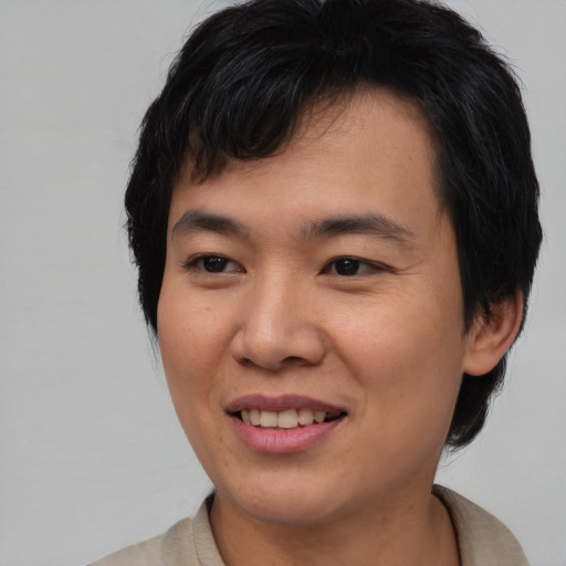 Joyful asian young-adult male with medium  brown hair and brown eyes
