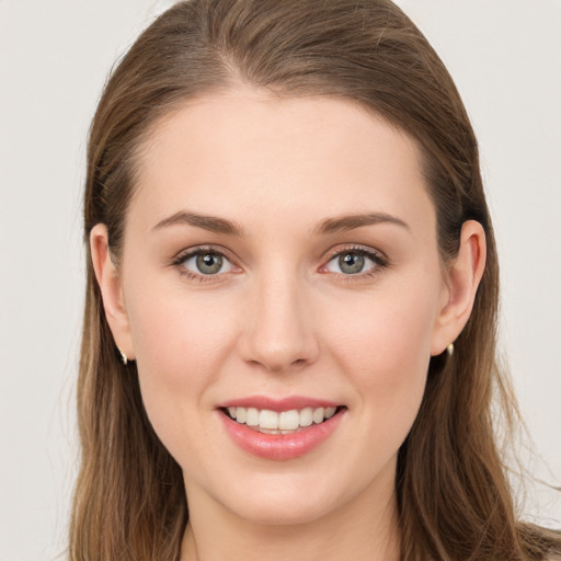 Joyful white young-adult female with long  brown hair and grey eyes