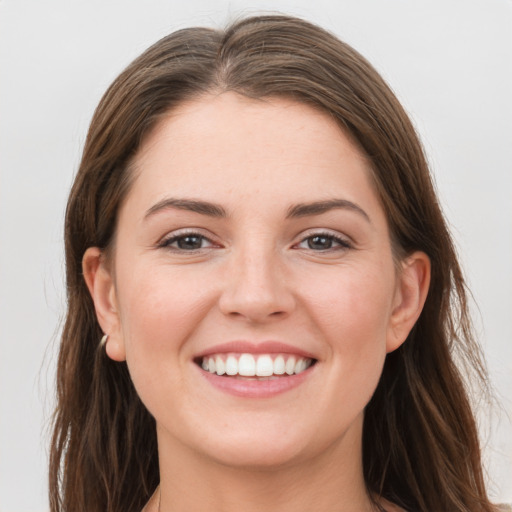 Joyful white young-adult female with long  brown hair and grey eyes