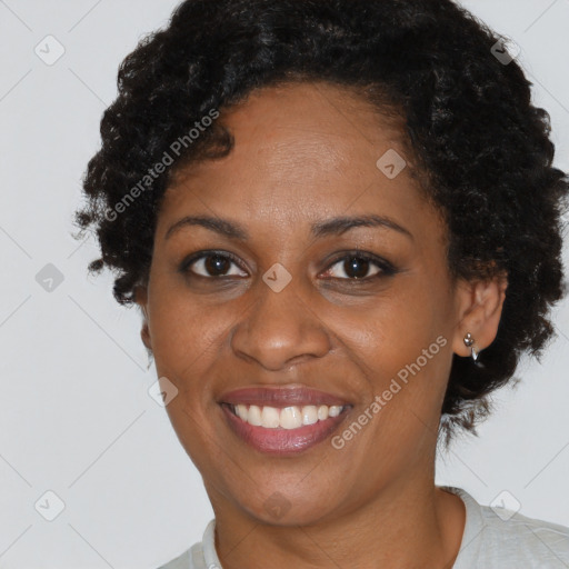 Joyful black adult female with short  brown hair and brown eyes