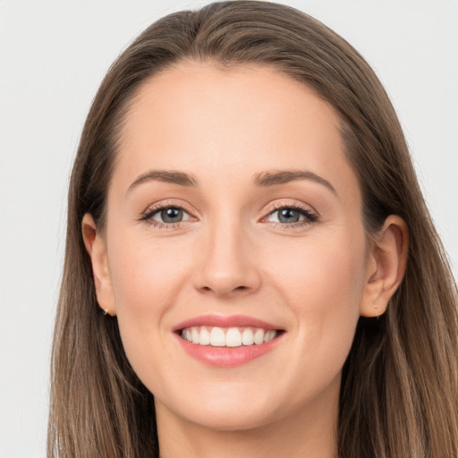 Joyful white young-adult female with long  brown hair and grey eyes