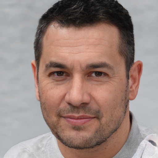 Joyful white adult male with short  brown hair and brown eyes