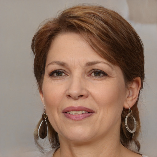 Joyful white adult female with medium  brown hair and brown eyes