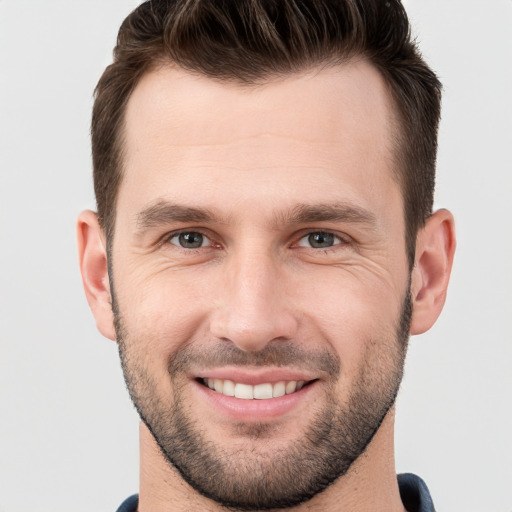 Joyful white young-adult male with short  brown hair and brown eyes