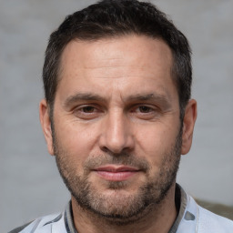 Joyful white adult male with short  brown hair and brown eyes