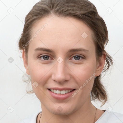 Joyful white young-adult female with medium  brown hair and grey eyes