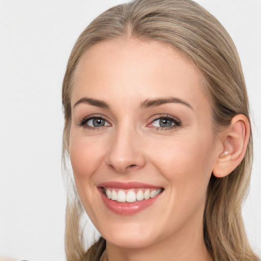 Joyful white young-adult female with long  brown hair and blue eyes