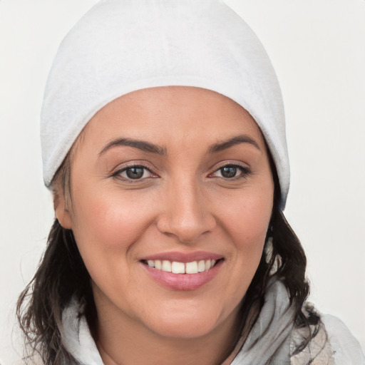 Joyful white young-adult female with medium  brown hair and blue eyes