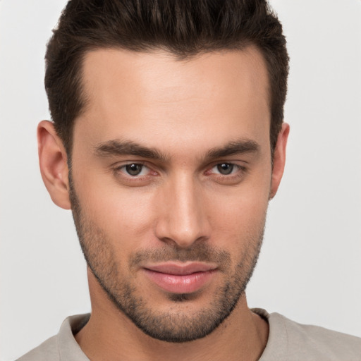 Joyful white young-adult male with short  brown hair and brown eyes