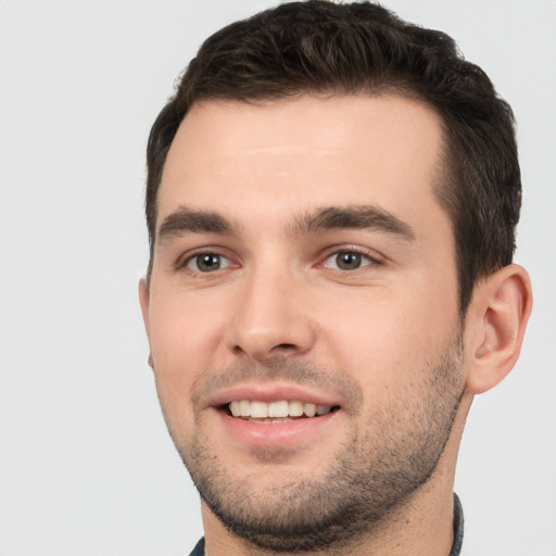 Joyful white young-adult male with short  brown hair and brown eyes