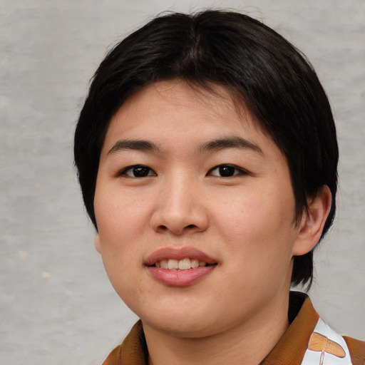Joyful asian young-adult female with short  brown hair and brown eyes