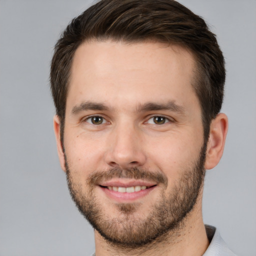 Joyful white young-adult male with short  brown hair and brown eyes