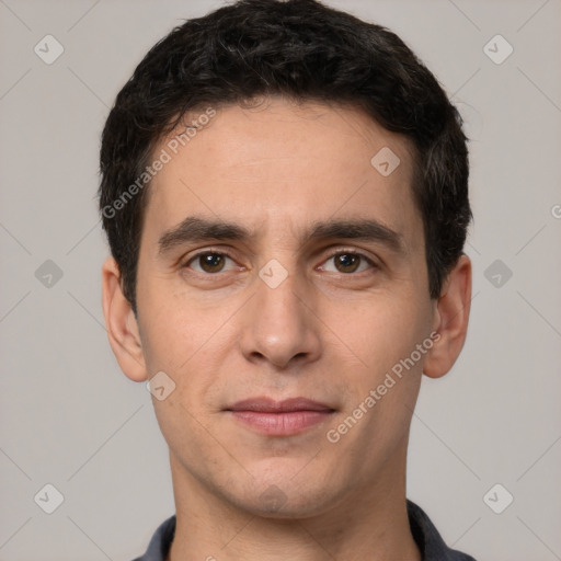 Joyful white young-adult male with short  black hair and brown eyes