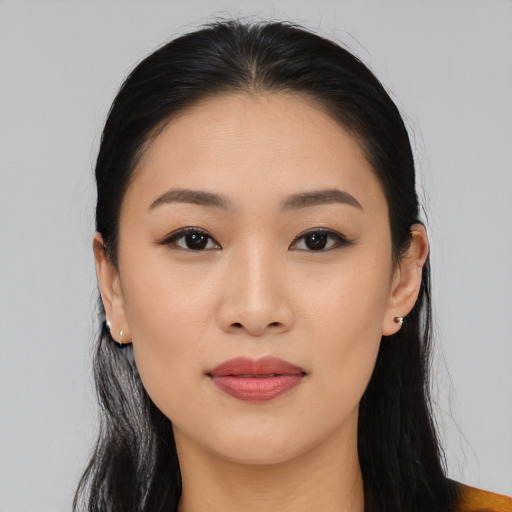 Joyful asian young-adult female with long  black hair and brown eyes