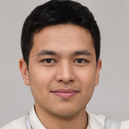 Joyful latino young-adult male with short  brown hair and brown eyes