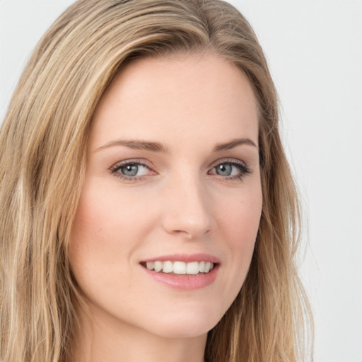 Joyful white young-adult female with long  brown hair and green eyes