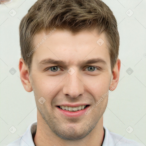 Joyful white young-adult male with short  brown hair and grey eyes