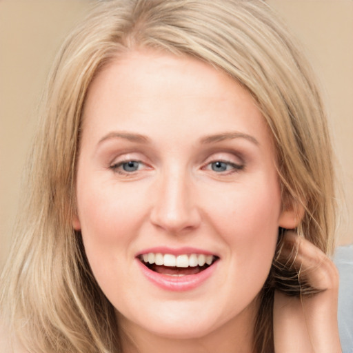 Joyful white young-adult female with long  brown hair and blue eyes