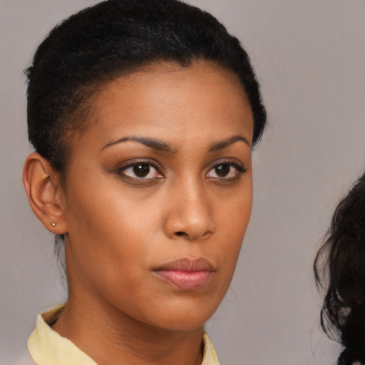 Neutral black young-adult female with medium  brown hair and brown eyes