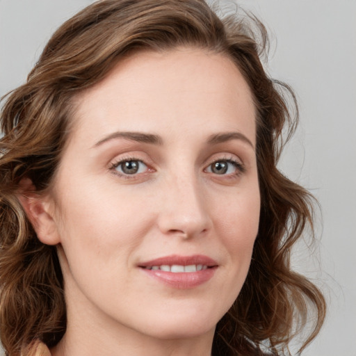 Joyful white young-adult female with medium  brown hair and blue eyes