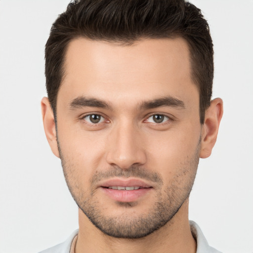 Joyful white young-adult male with short  brown hair and brown eyes