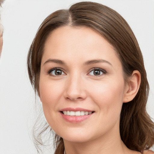 Joyful white young-adult female with long  brown hair and brown eyes