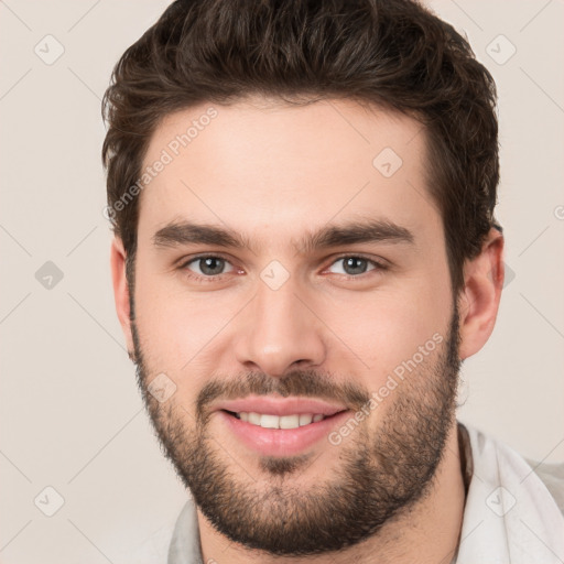 Joyful white young-adult male with short  brown hair and brown eyes