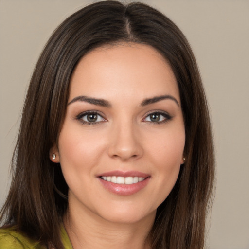 Joyful white young-adult female with long  brown hair and brown eyes