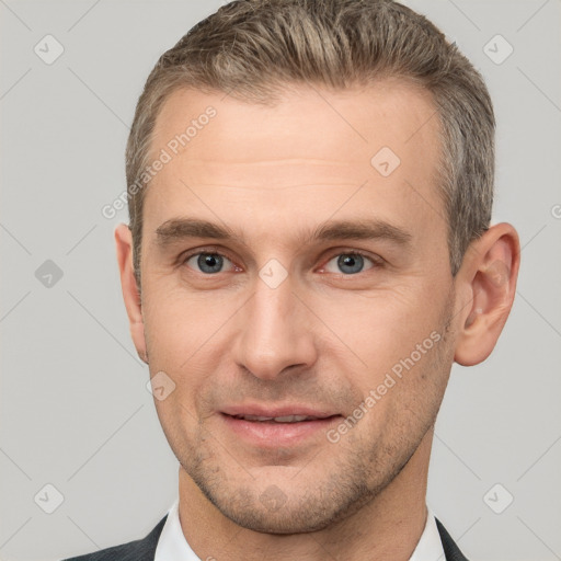 Joyful white adult male with short  brown hair and brown eyes