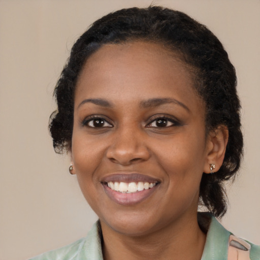 Joyful black young-adult female with medium  black hair and brown eyes