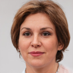 Joyful white adult female with medium  brown hair and brown eyes