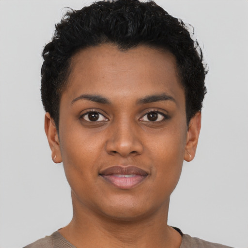 Joyful black young-adult female with short  black hair and brown eyes