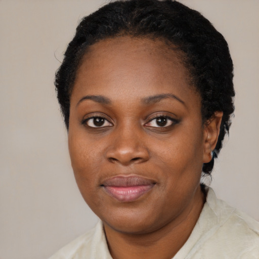 Joyful black young-adult female with short  brown hair and brown eyes