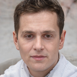 Joyful white adult male with short  brown hair and brown eyes